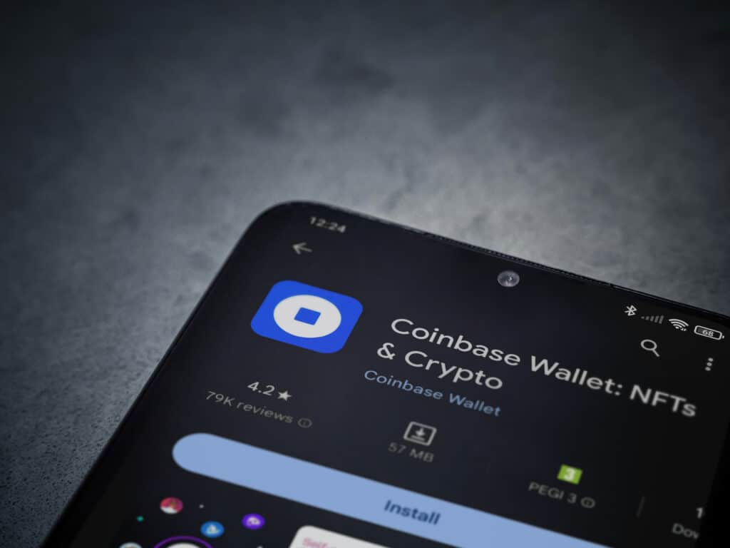 Coinbase Wallet app play store page on smartphone on a dark marble stone background.