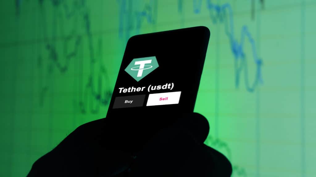 A phone shows the USDT price to invest