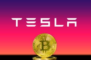 Bitcoin coin on Tesla logo background.