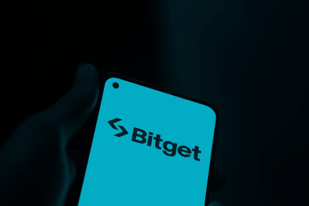 Bitget logo is displayed on smartphone.
