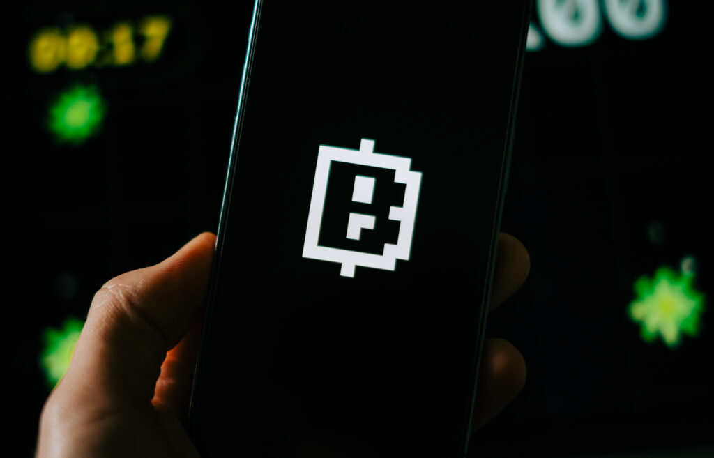 Blum Crypto telegram bot logo on mobile phone screen.