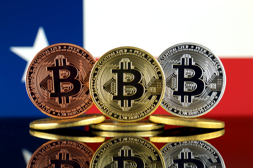 Physical version of Bitcoin (BTC) and Texas State Flag.