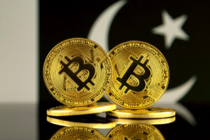 Physical version of Bitcoin and Pakistan Flag.