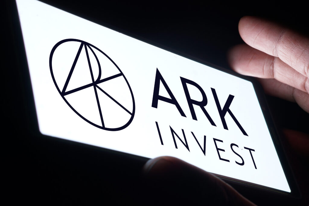 ARK Investment Management LLC logo is displayed on smartphone.