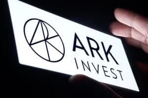 ARK Investment Management LLC logo is displayed on smartphone.