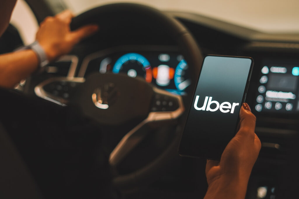 Uber logo is displayed on a smartphone screen.