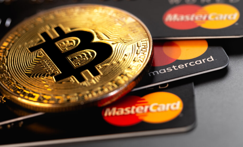 bitcoin cryptocurrency with MasterCard plastic electronic cards closeup.