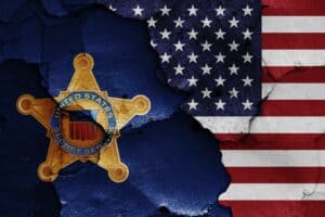 Flags of United States Secret Service and USA painted on cracked wall