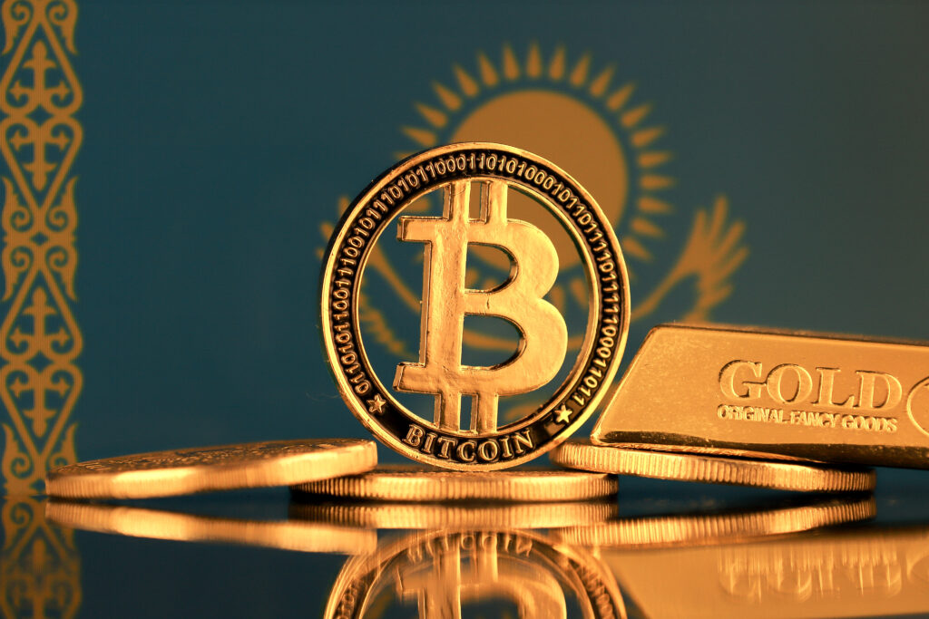 Physical version of Bitcoin, gold bar and Kazakhstan Flag.