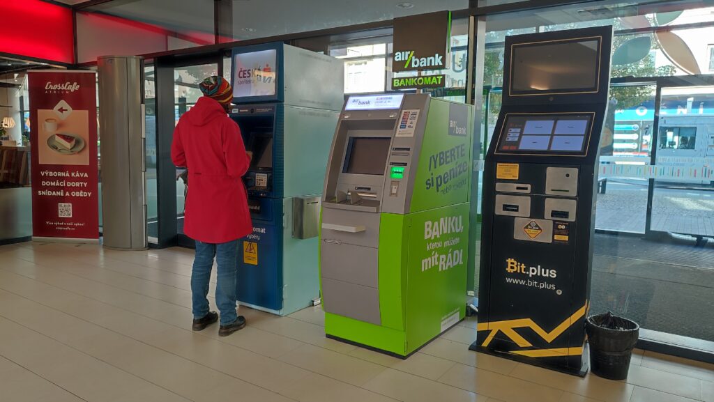 a machine in a supermarket exchanging bitcoins for crowns