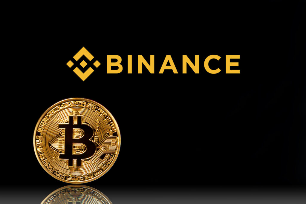 Binance logo with bitcoin on black background.
