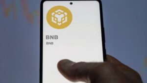 Close up on logo of BNB crypto asset on the screen of an exchange.