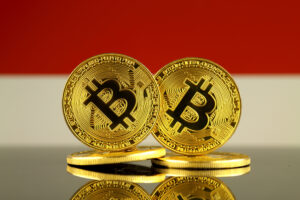 Physical version of Bitcoin and Indonesia Flag. Close up.