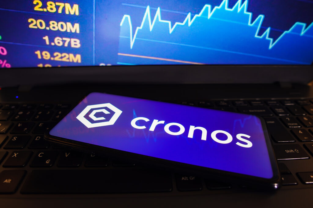 Cronos (CRO) logo is displayed on a smartphone screen.
