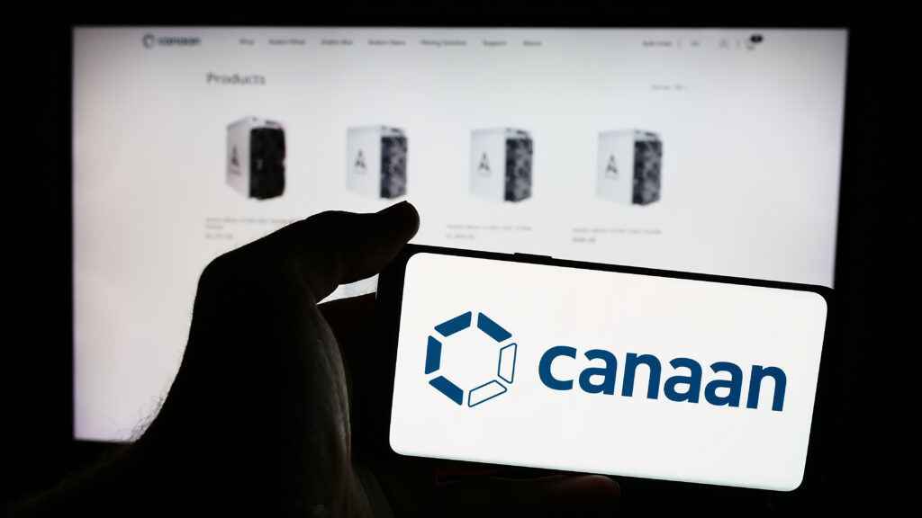 Person holding mobile phone with logo of Chinese computer hardware company Canaan Inc. in front of business web page.